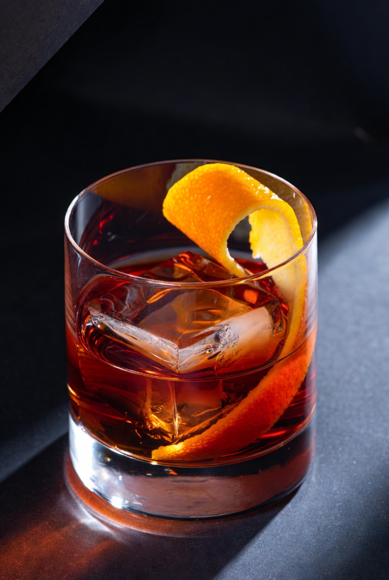 Old Fashioned over a single large cube with an orange twist